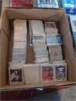 Box of baseball and football cards and sleeves