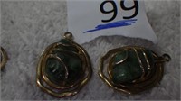 Green jade mounted in gold colored metal earrings,