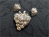 Silver toned metal brooch with earrings