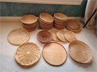 Large lot of Wicker plate holders & serving trays.