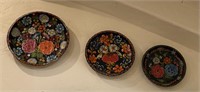 Four decorative hand painted wooden bowls