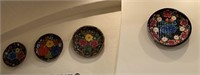 Four decorative hand painted wooden bowls