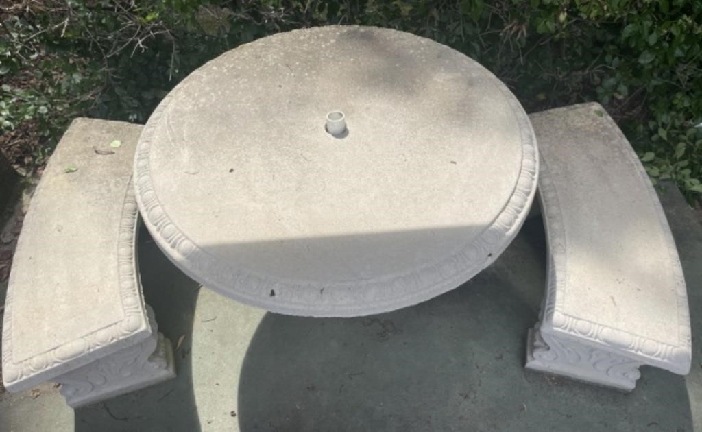Round concrete table with three benches