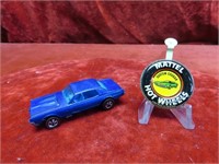 Red line Hot Wheels diecast car & button.