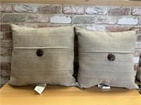 Pair of tan pillows with button
