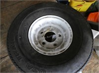 Trailer wheel and tire - in middle shop - see atta