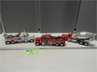 2 Peterbilt tow trucks and a Kenworth cement truck