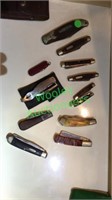12 pocket knives in group