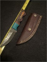 Damascus steel knife with leather case.