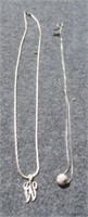 (2) Sterling silver necklaces with pendants.