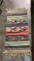 Multicolored Navajo style rug with tassel ends