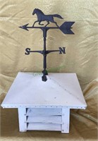 Small vintage metal weathervane attached to roof