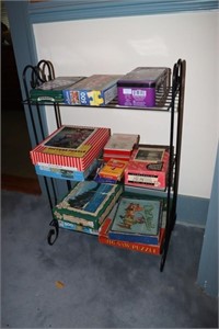 Wrought iron stand with old puzzles and card