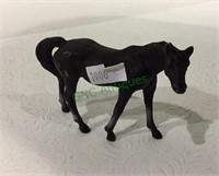 Miniature metal horse measuring 2 inches tall.