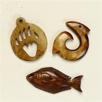 Three vintage brown ivory pendants