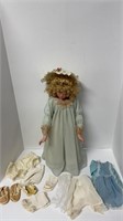 Porcelain doll w/ additional outfits