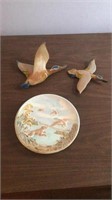 Wooden ducks in flight and plate