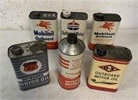 6 empty outboard motor oil tins