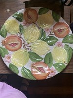 Plate with raised lemon and fruit design made in