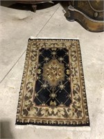 Petite hand made entry or transition rug