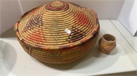 Brightly colored woven coil basket with a