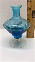 Blue glass vase with marbles