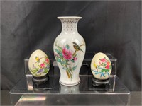 2 hand painted eggs and a vase.