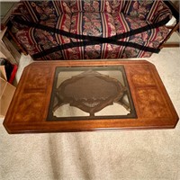 Coffee table, wood with glass in the center.