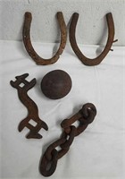 Vintage or antique horseshoes, cannonball, chain,