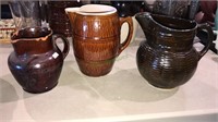 Three pottery pitchers, The tallest one is 8 1/2