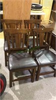 Four matching chairs with leather like cushion