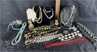 Costume jewelry including many beaded necklaces,