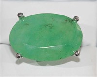 Large emerald dress ring set with an oval