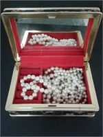 Small Vintage jewelry box with strands of pearls