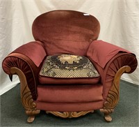 Upholstered side chair with carved arm decor on