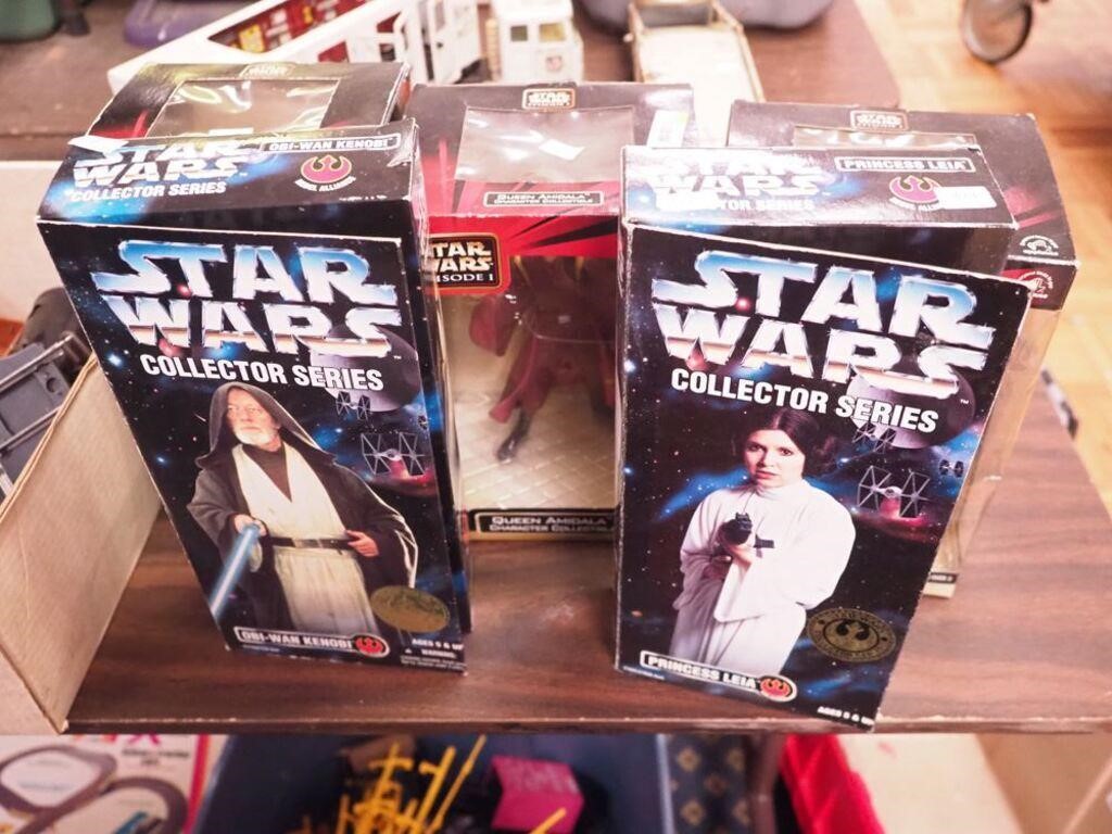 Five Star Wars-related figurines in boxes: three
