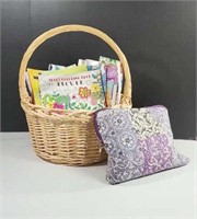 Adult coloring books in large basket with colored