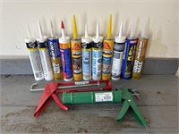 Two caulk guns with 11 tubes of caulk