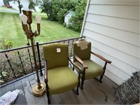 Two green rocking chairs and a floor lamp