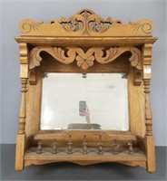 Antique carved oak wall shelf with beveled mirror