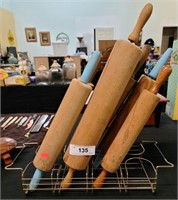 Six antique rolling pins in rack