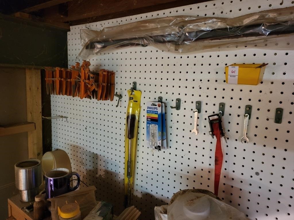 Assortment of tools on wall clamps and saws