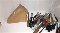 Empty wooden knife block and assortment of