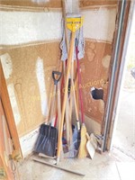 Assorted long handle tools in corner