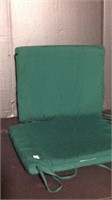 Three emerald green seat cushions, three