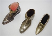 Three vintage metal shoe form pin cushions