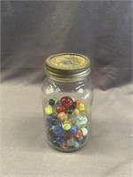 7 INCH CANNING JAR WITH ASSORTED VINTAGE MARBLES