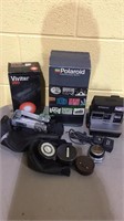 Group of camera items, includes a Polaroid