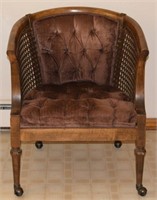 Vintage caned sides castered lounge arm chair