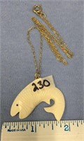 1 1/2" carved ivory fish pendant, on a 9" gold ton